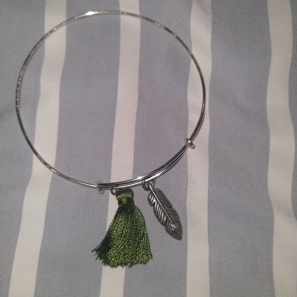 Silver bracelet with green feather